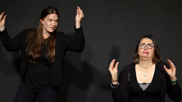 two females performing improv