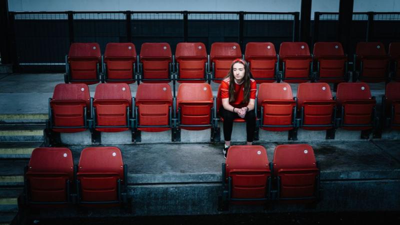 person sitting in an empty stadium