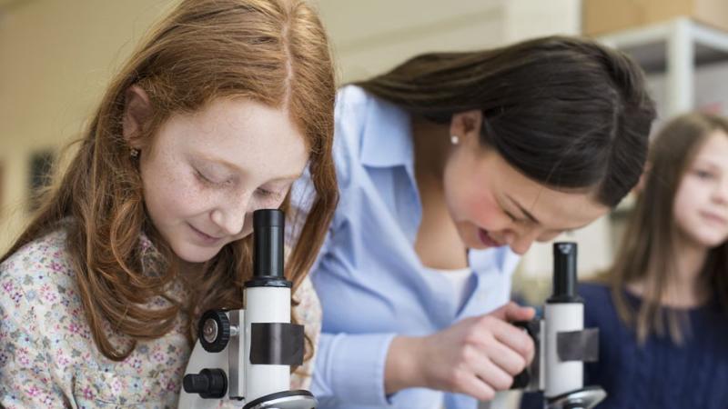 kids looking through microscopes