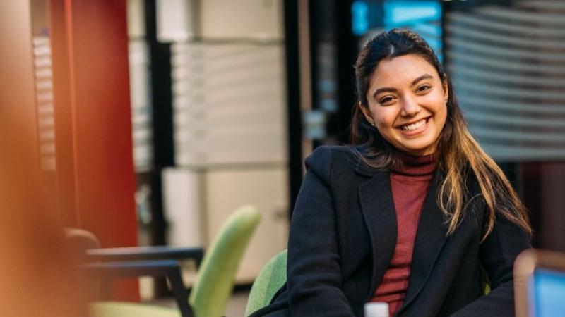 student sitting smiling to camera