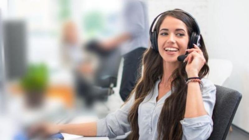 female sitting at a desk with headset on