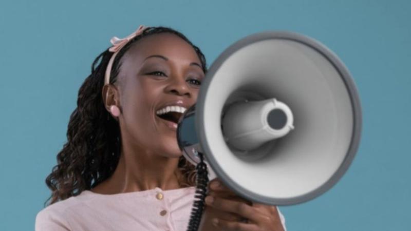 female student shouting through a loudspeaker