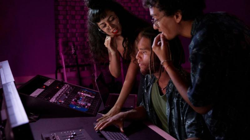 three students working in a digital studio