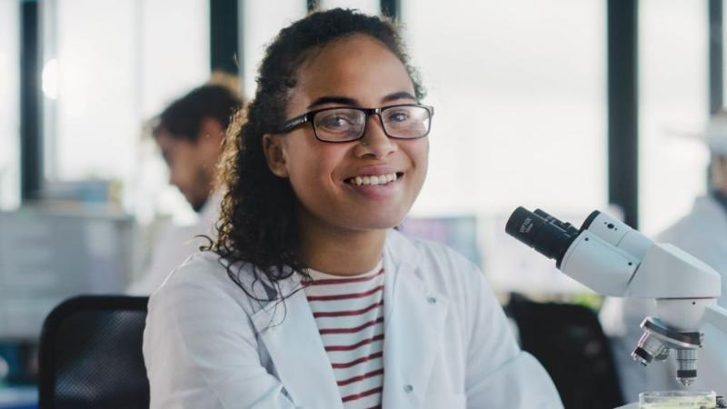 female scientist in a white coat in a lab