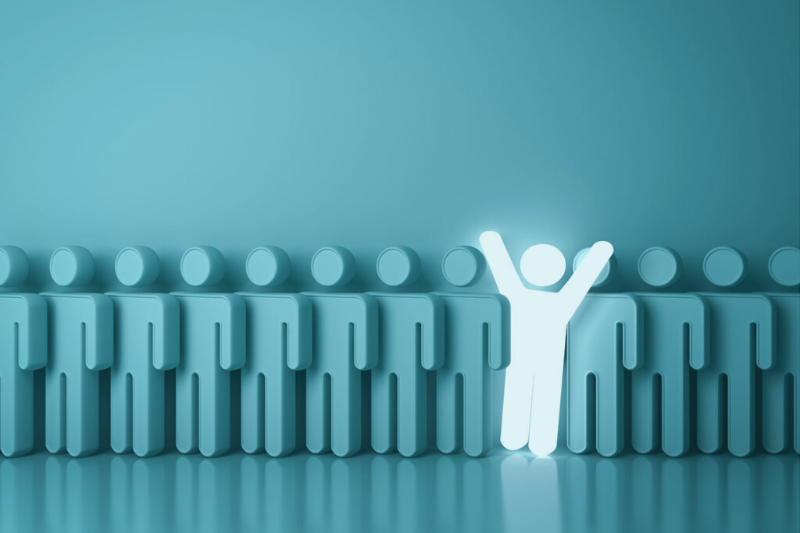 one illuminated stick man amongst other dull stick men