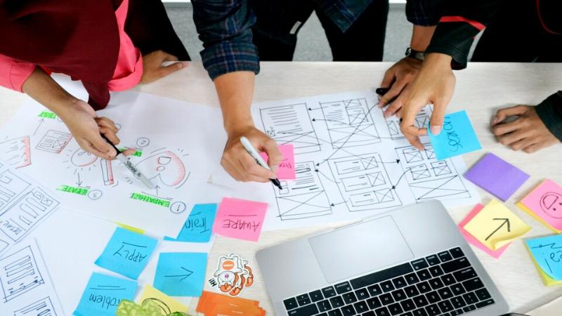 Group of people brainstorming ideas with notes during a workshop