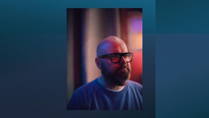 Person wearing glasses looking to the side.