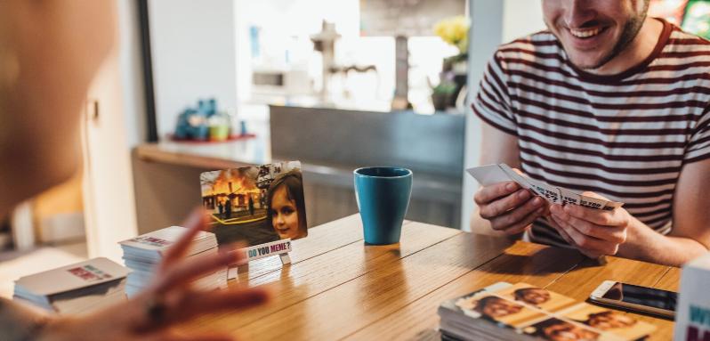 Two students playing a board game in Queen