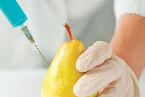 Someone injecting a pear