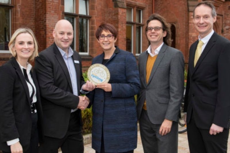 Staff at Queen's receiving a cycle friendly award