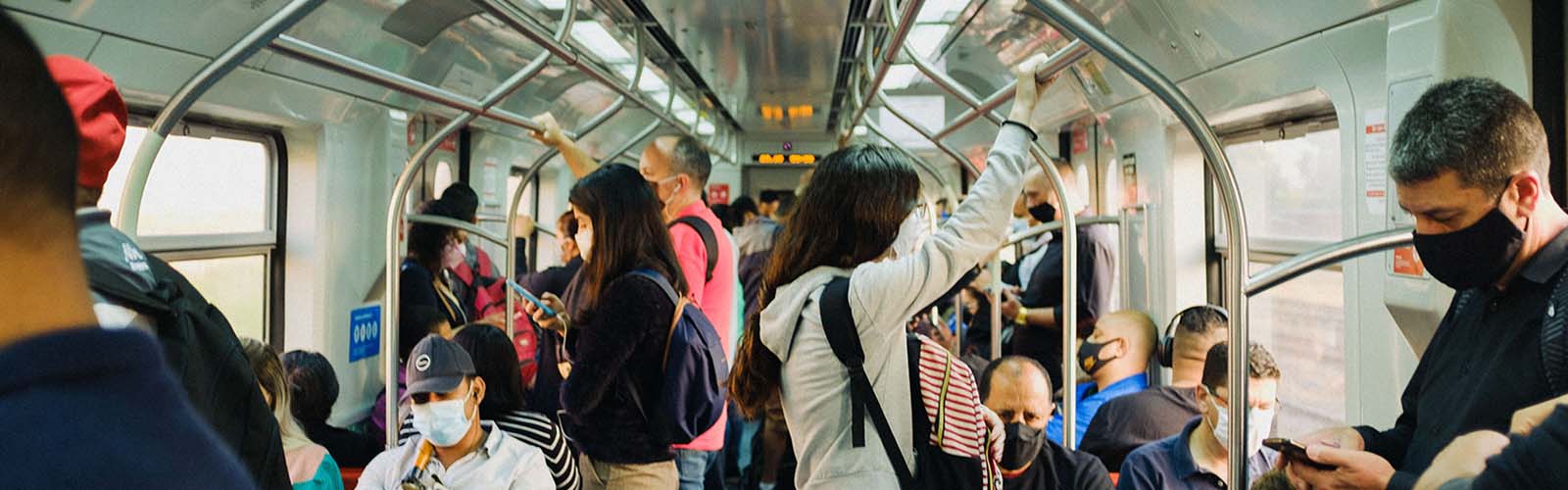 People standing and sitting on a crowded bus