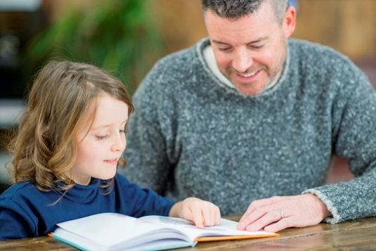 School child and teacher reading