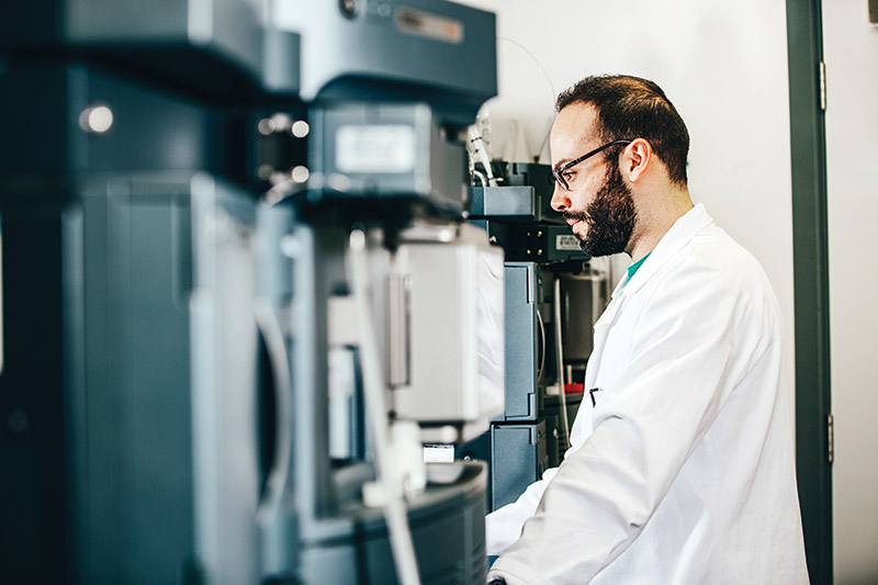 Researcher working at a machine