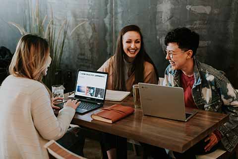 smiling workers on laptops