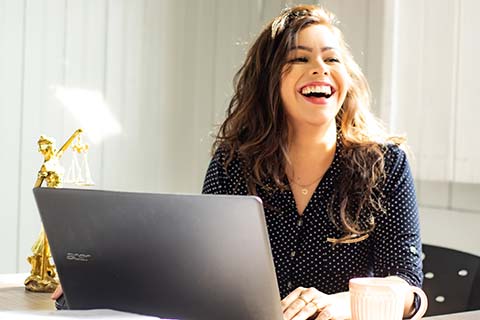 Smiling worker on a laptop