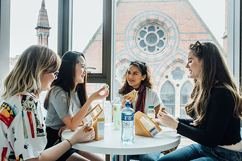 Students eating sandwiches in the law building