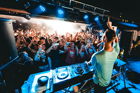 People dancing in front of a DJ