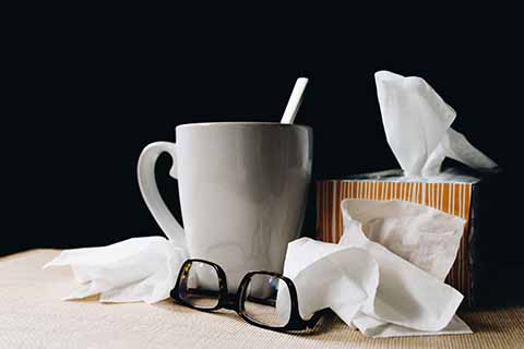 tissues, cup and glasses on a table