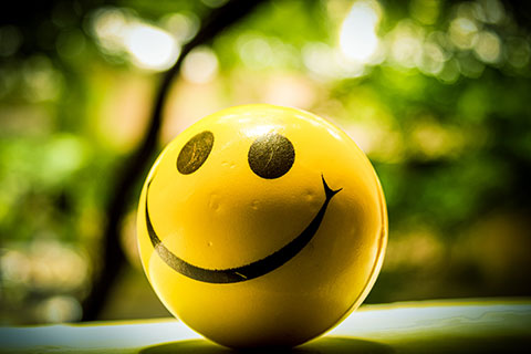 Yellow stress ball with a smiling face