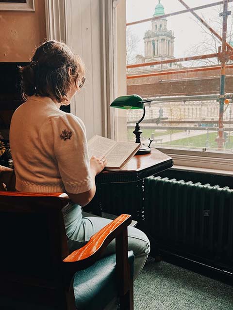 Tessa in Linen Hall Library with City Hall View