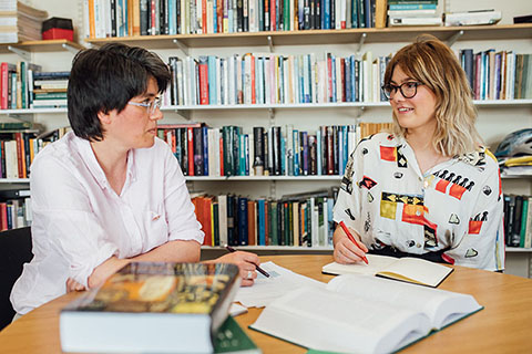 Student talking to lecturer Maire Coleman