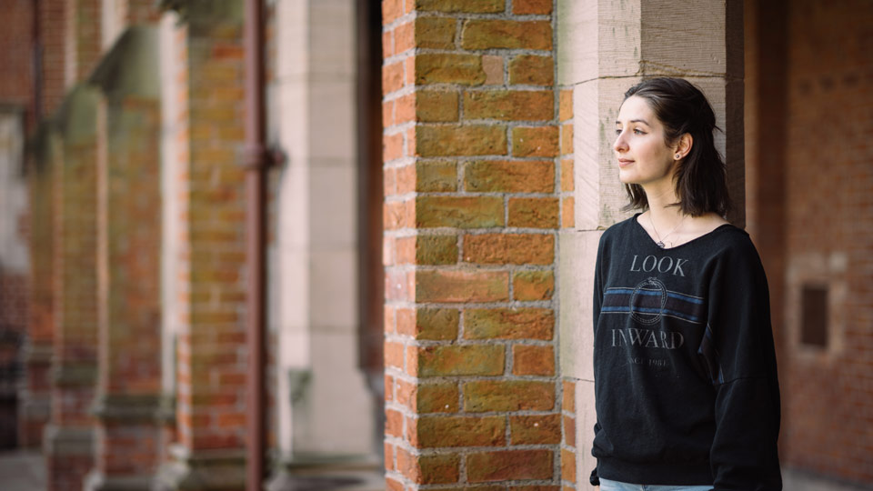 Girl looking into the distance outside of the Lanyon Building