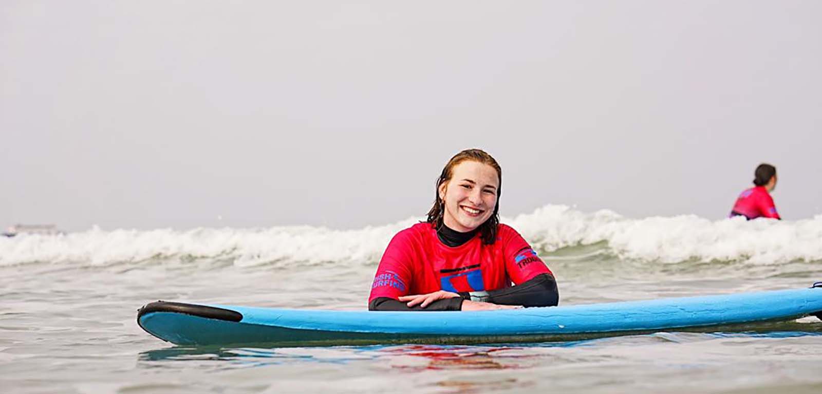 Tessa on a surf board