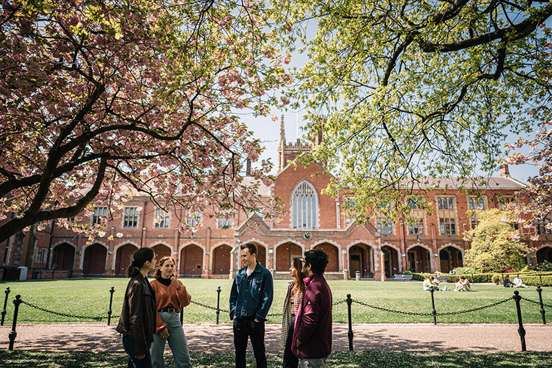 Group of students under a cherry blossom in the quad