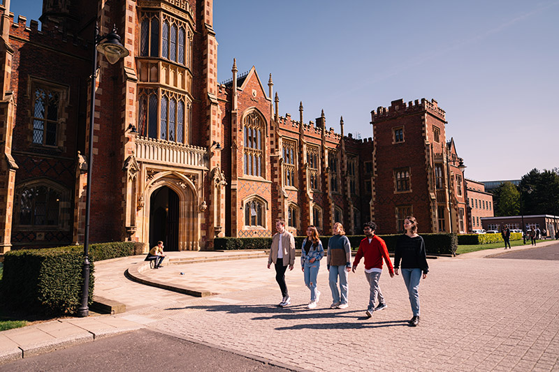 Group of students walking past Lanyon