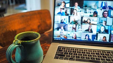 Zoom screen on a laptop and a mug