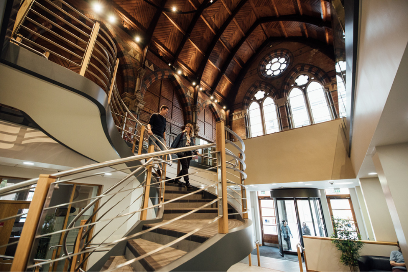 Students on the staircase in the Graduate School