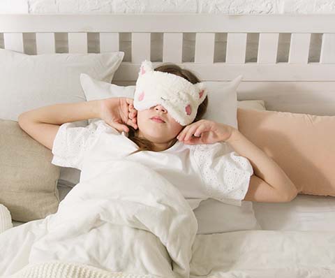 Person sleeping with a mask on