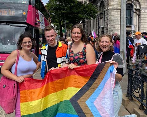Patrick and friends with Pride flag