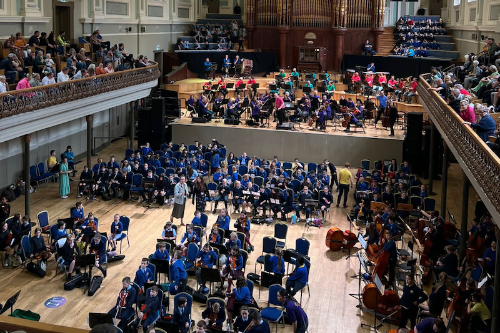 School children and orchestra fill the Ulster Hall