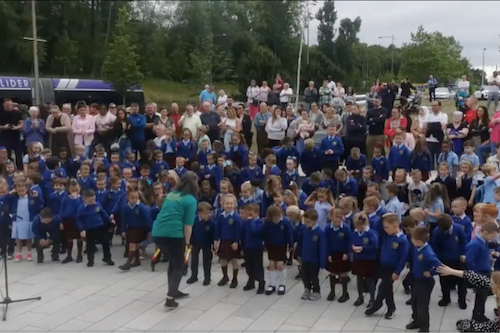 Crescendo children singing outside, with Ulster Orchestra member