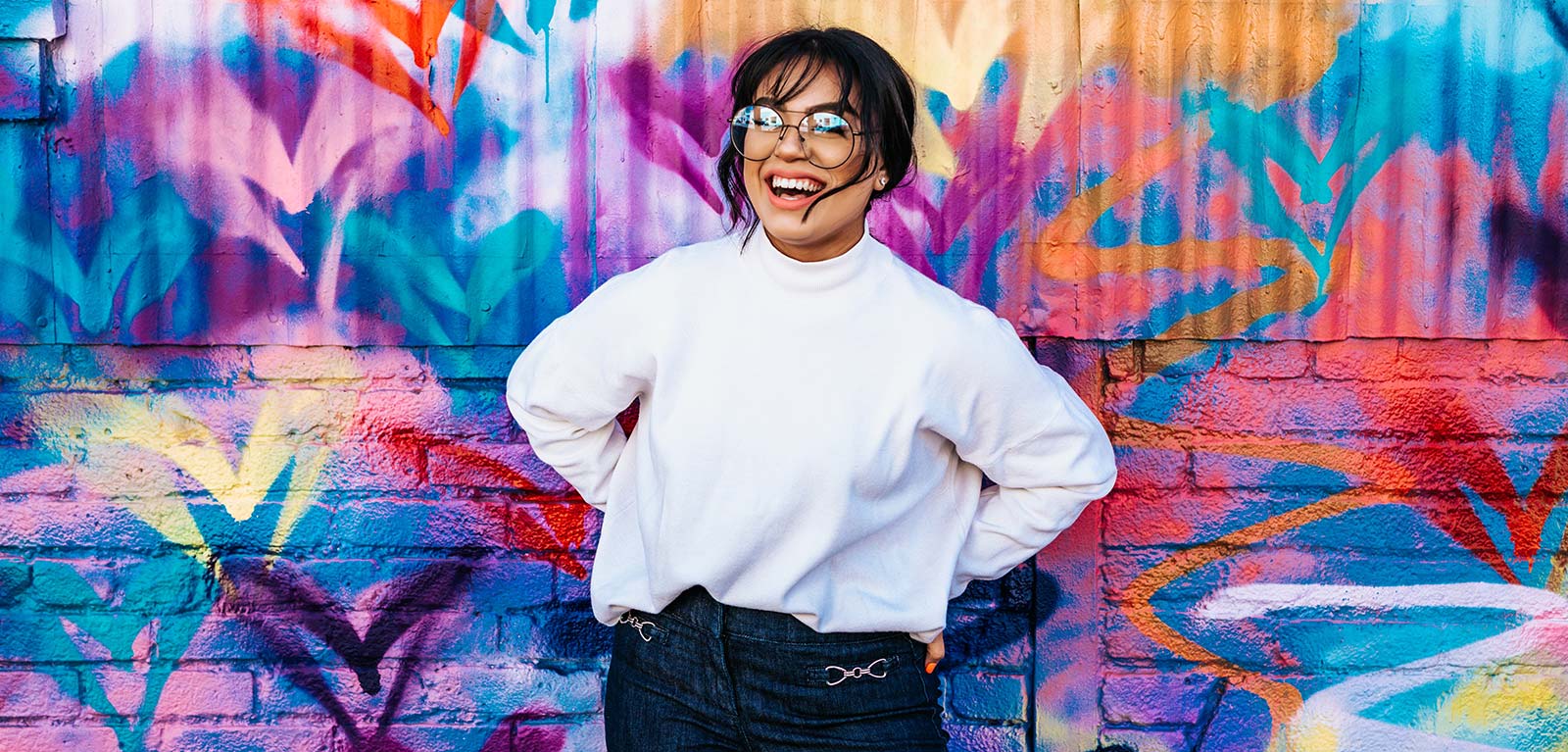 Smiling girl with colourful graffiti background