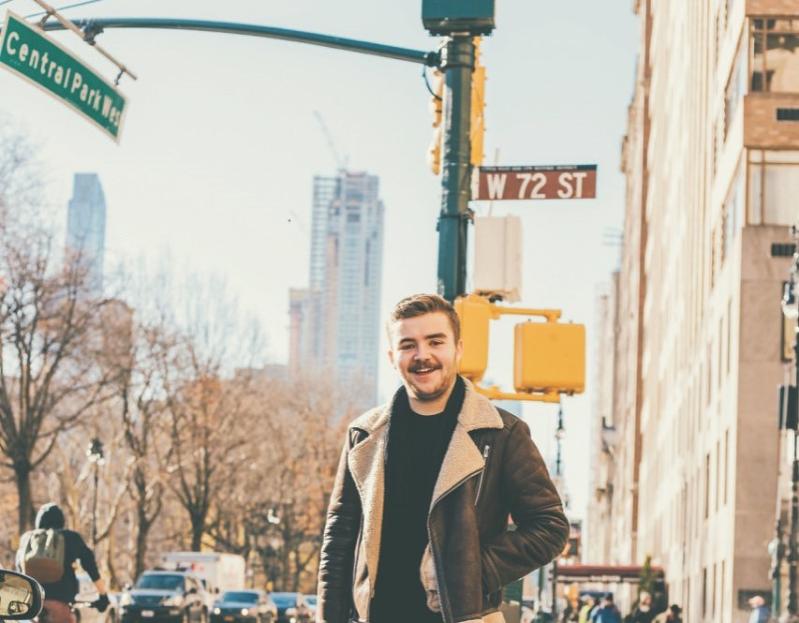 Man standing at traffic lights in America