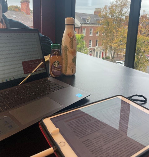 laptop and drinks by the library window