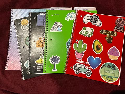 notebooks with stickers on them