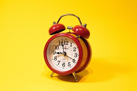 Alarm clock on a yellow background