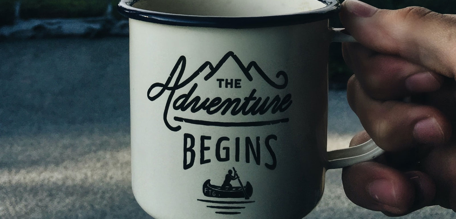 A cup with the adventure begins written on it