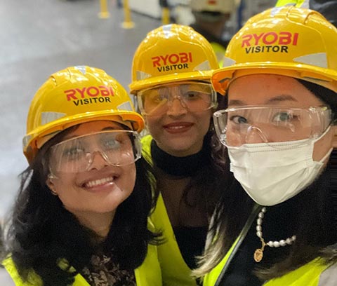 Students on a factory tour wearing hard hats