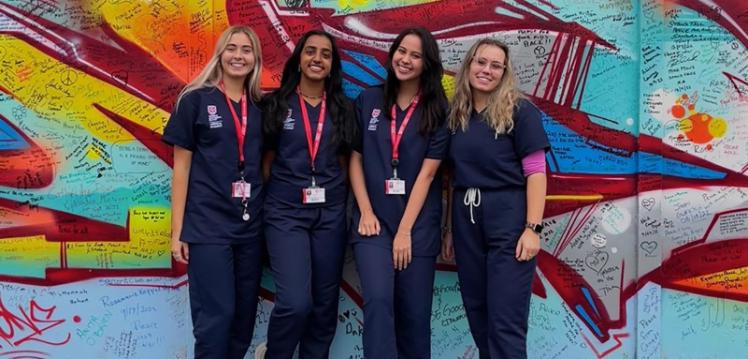 Disha and her medical student pals in scrubs