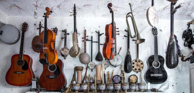 Lots of musical instruments hanging on a wall