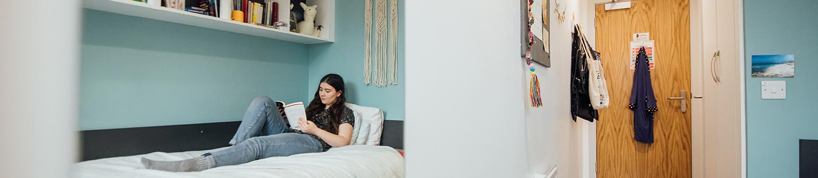 Student sitting on her bed