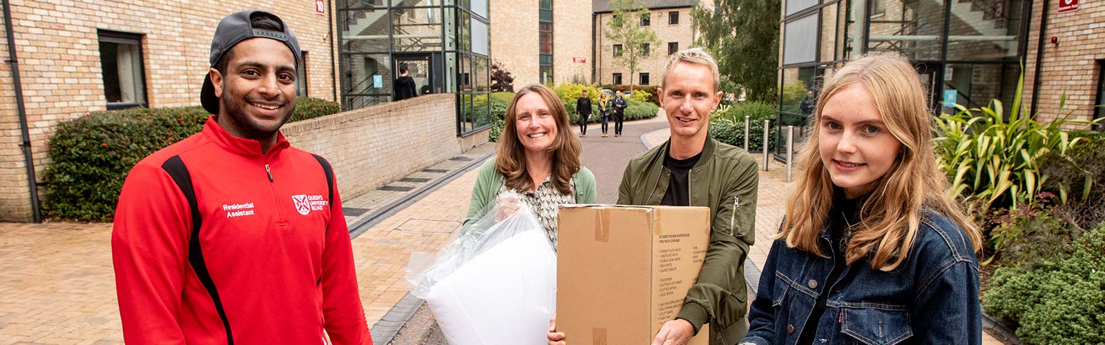 Parents carrying boxing at moving in day