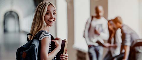 smiling girl carrying books