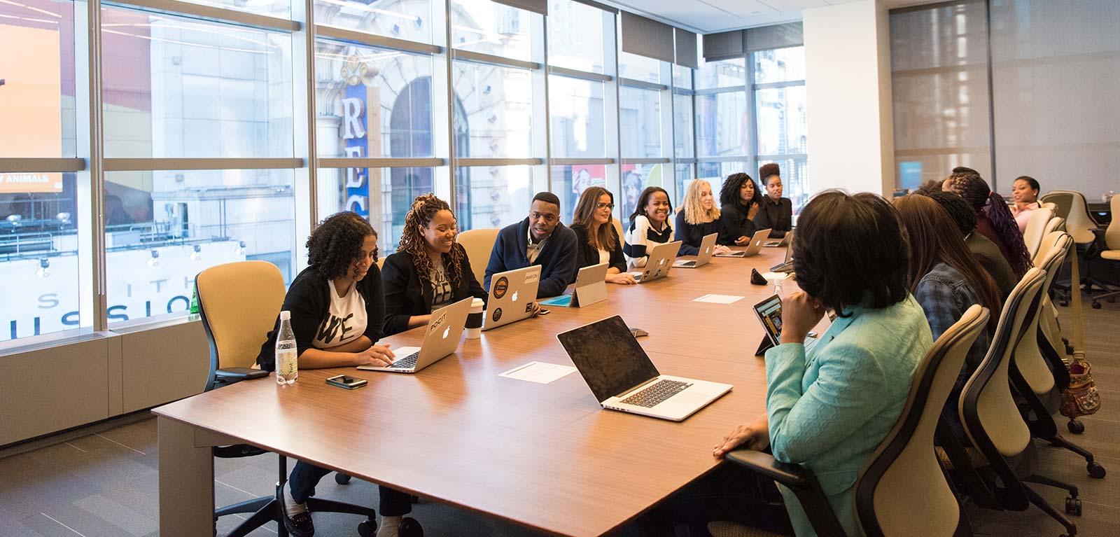 Lots of people in a work situation sitting round a bit table