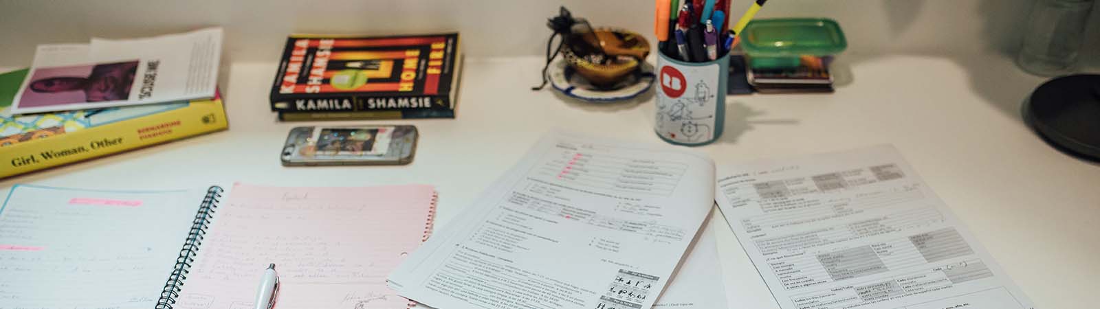 Desk with papers and pens