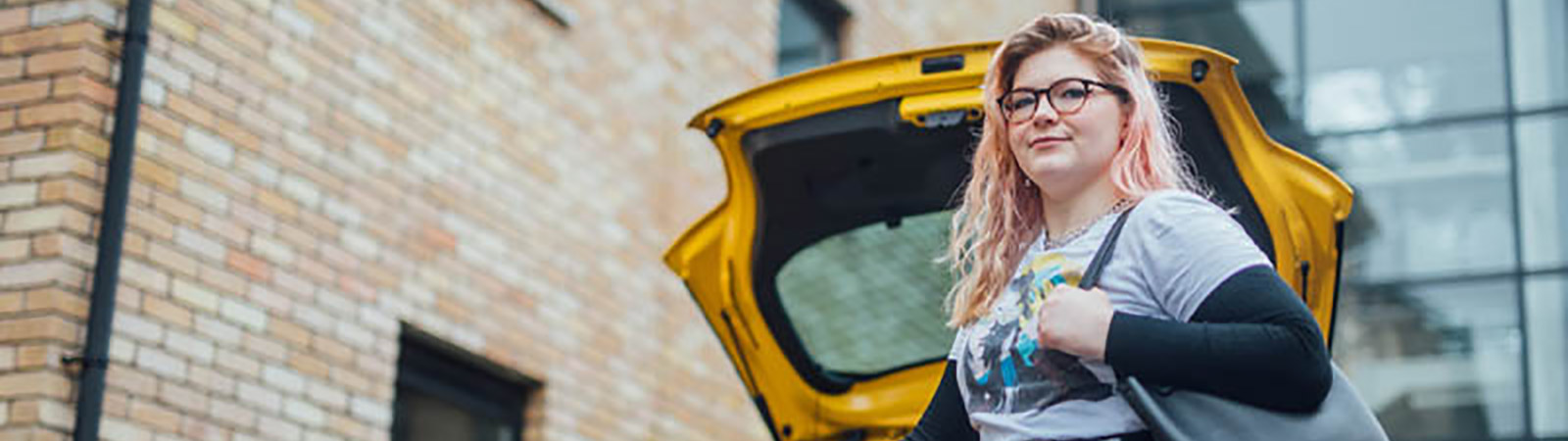 Girl at her car boot with a bag